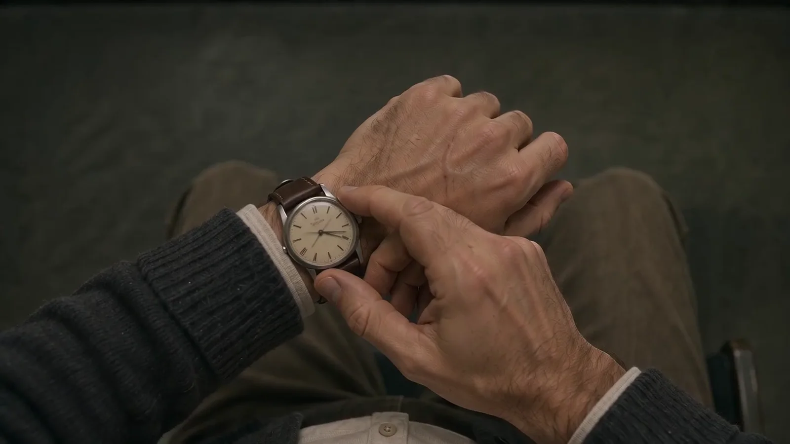 Eli adjusts the worn watch on his left wrist